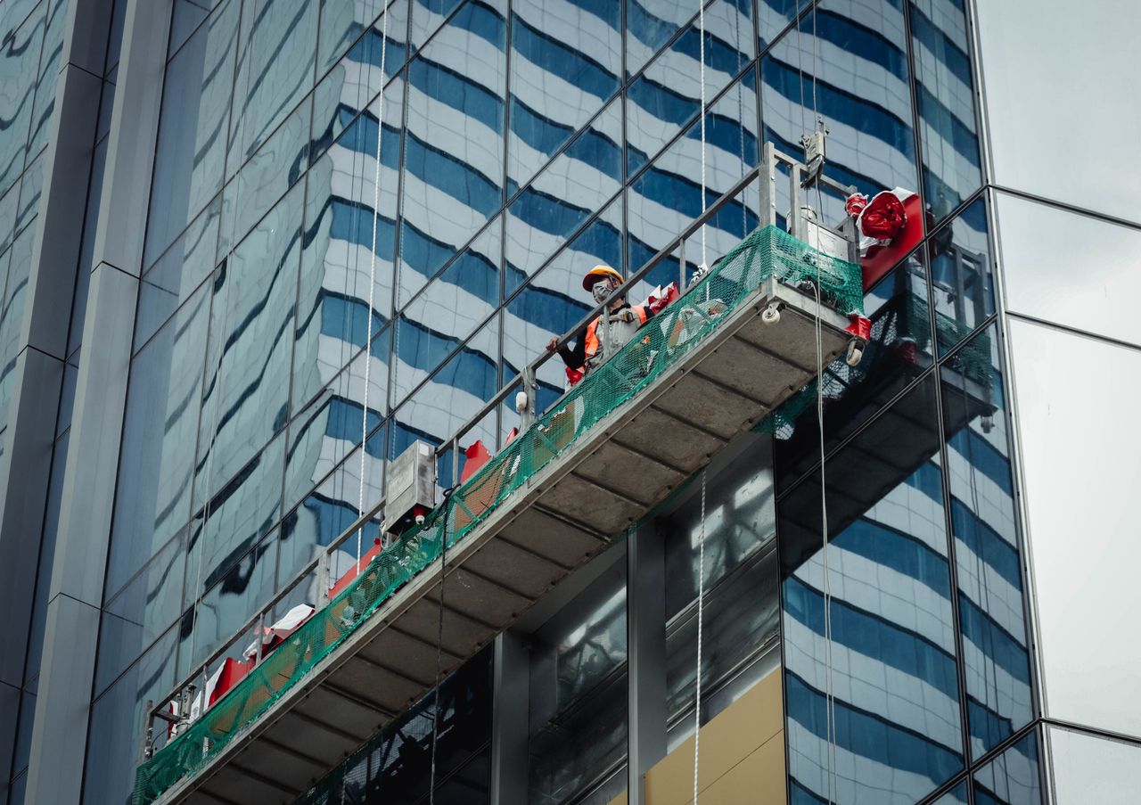 about-02 Urban worker cleaning windows on a high-rise in Ho Chi Minh City, Vietnam.